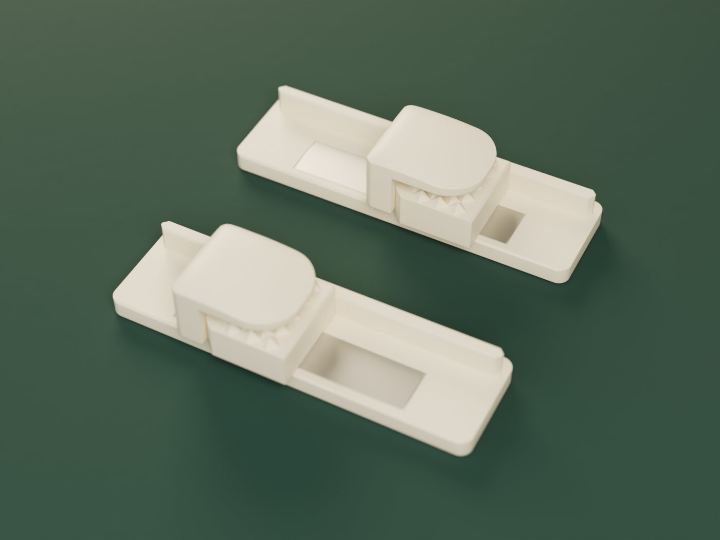 The Prayer Mat Hanger kit in ivory: two wall mounts, each with a clamp resting on it, on a deep green cloth